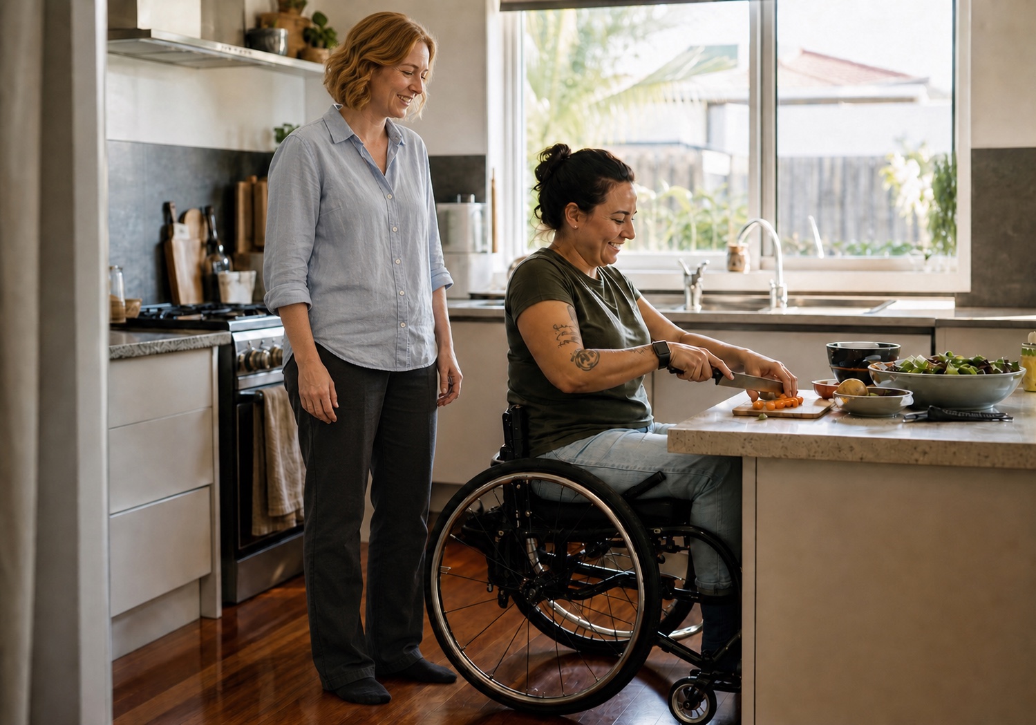 A wheelchair user preparing a meal at home while another person stands alongside her